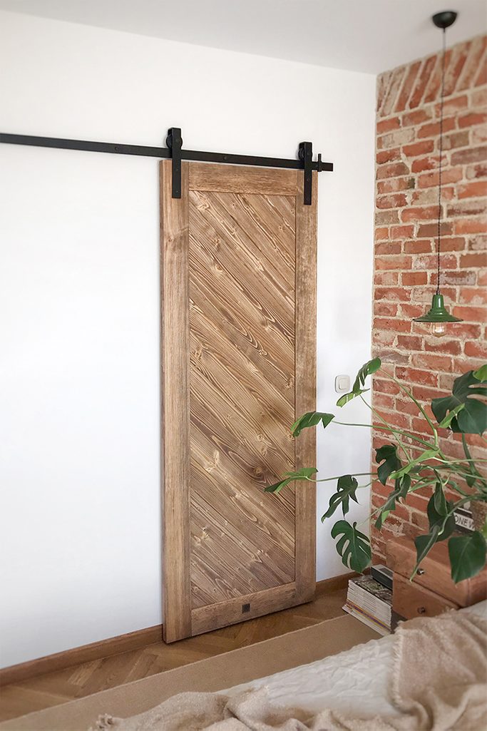 wooden sliding door, wardrobe door, bedroom dressing room, sliding wardrobe door, wooden door, brick in the bedroom, hanging bedside lamp, vintage style, vintage bedroom