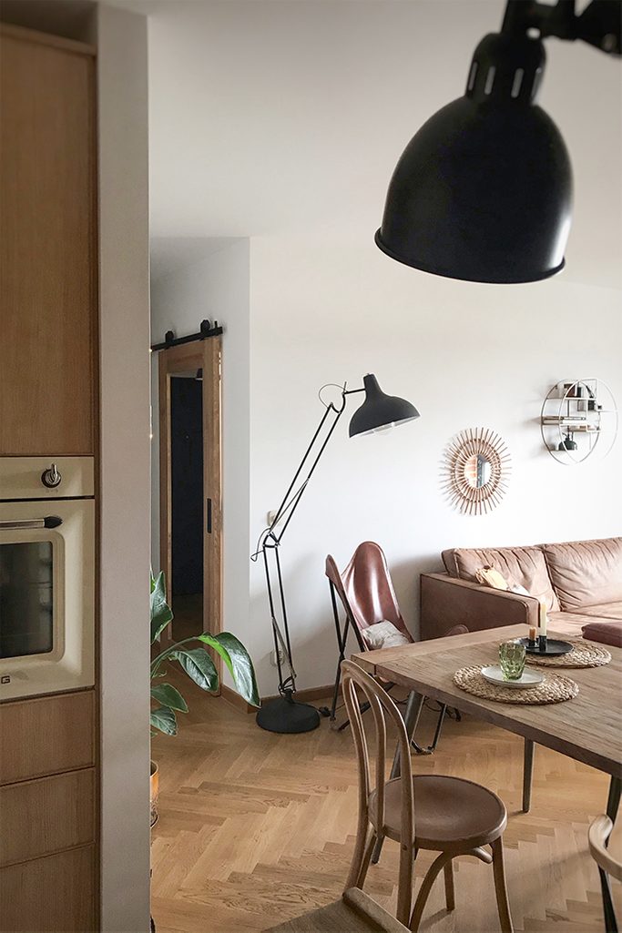 sliding door to office, wooden door with mirror, sliding door with mirror, large metal standing lamp, leather armchair on a metal base, vintage armchair, parquet floor in the living room, mirror in the hallway, retro chairs