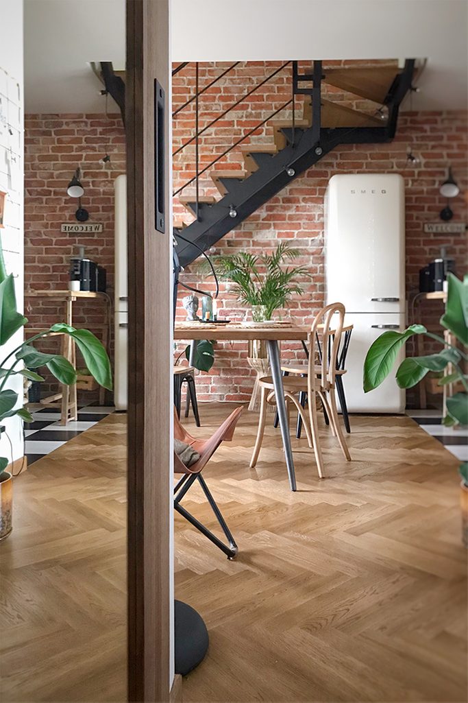 loft interior, vintage furniture, loft stairs, brick on the wall in the living room, vintage fridge, retro accessories for the apartment, industrial lamps, parquet in the living room