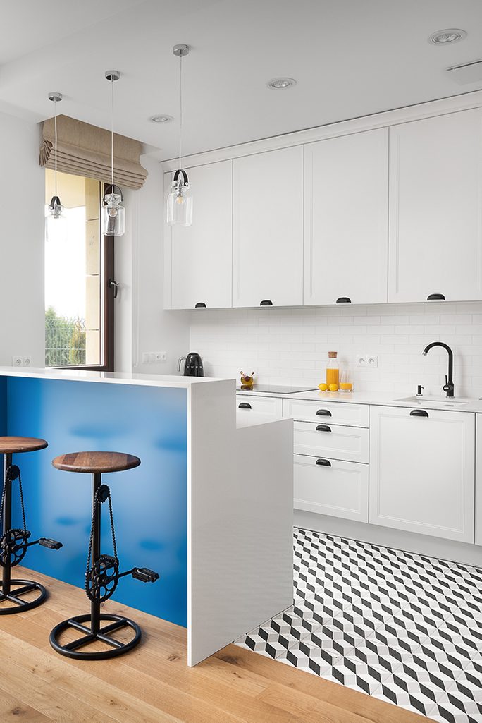 white kitchen with black accessories, white and black kitchen floor, industrial bar stool with bike pedals