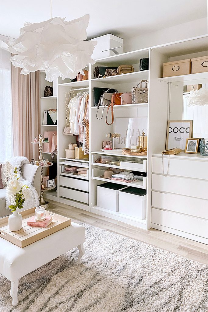 system of white shelves in the dressing room, large bright dressing room, white shelves, white seat in the dressing room, crumpled paper pendant lamp