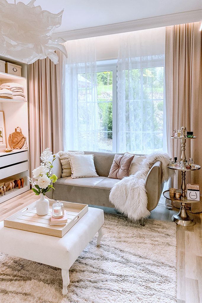 white seat and gray sofa in the dressing room, large bright dressing room, white hanging lamp, bright dressing room, crumpled paper pendant lamp