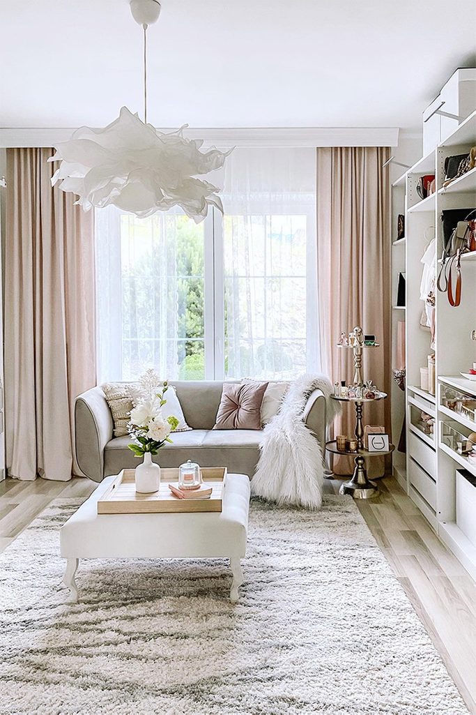 white seat and gray sofa in the dressing room, large bright dressing room, white hanging lamp, bright dressing room, crumpled paper pendant lamp