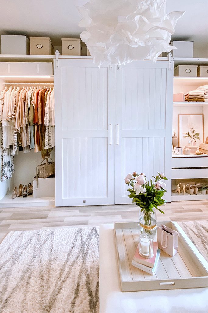 crumpled paper pendant lamp, white sliding doors for the wardrobe, barn door in the dressing room, a system of white wardrobes and shelves in the dressing room, large wardrobe in white, white doors on a white sliding system